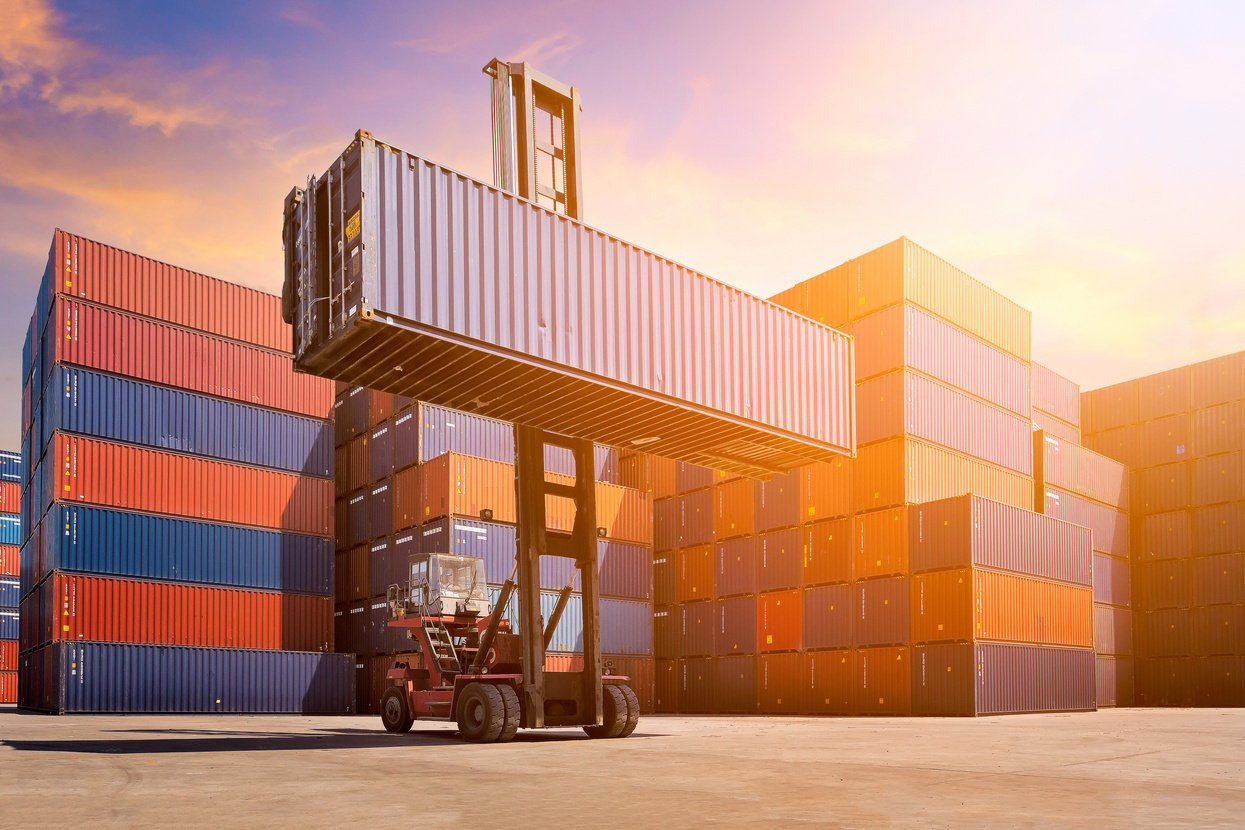 Logistic cargo container in shipping yard with cargo container stack in background